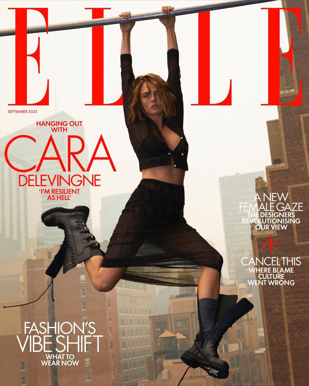 Elle Magazine cover featuring Cara Delevingne hanging from a bar in a black sheer outfit with city buildings in the background.