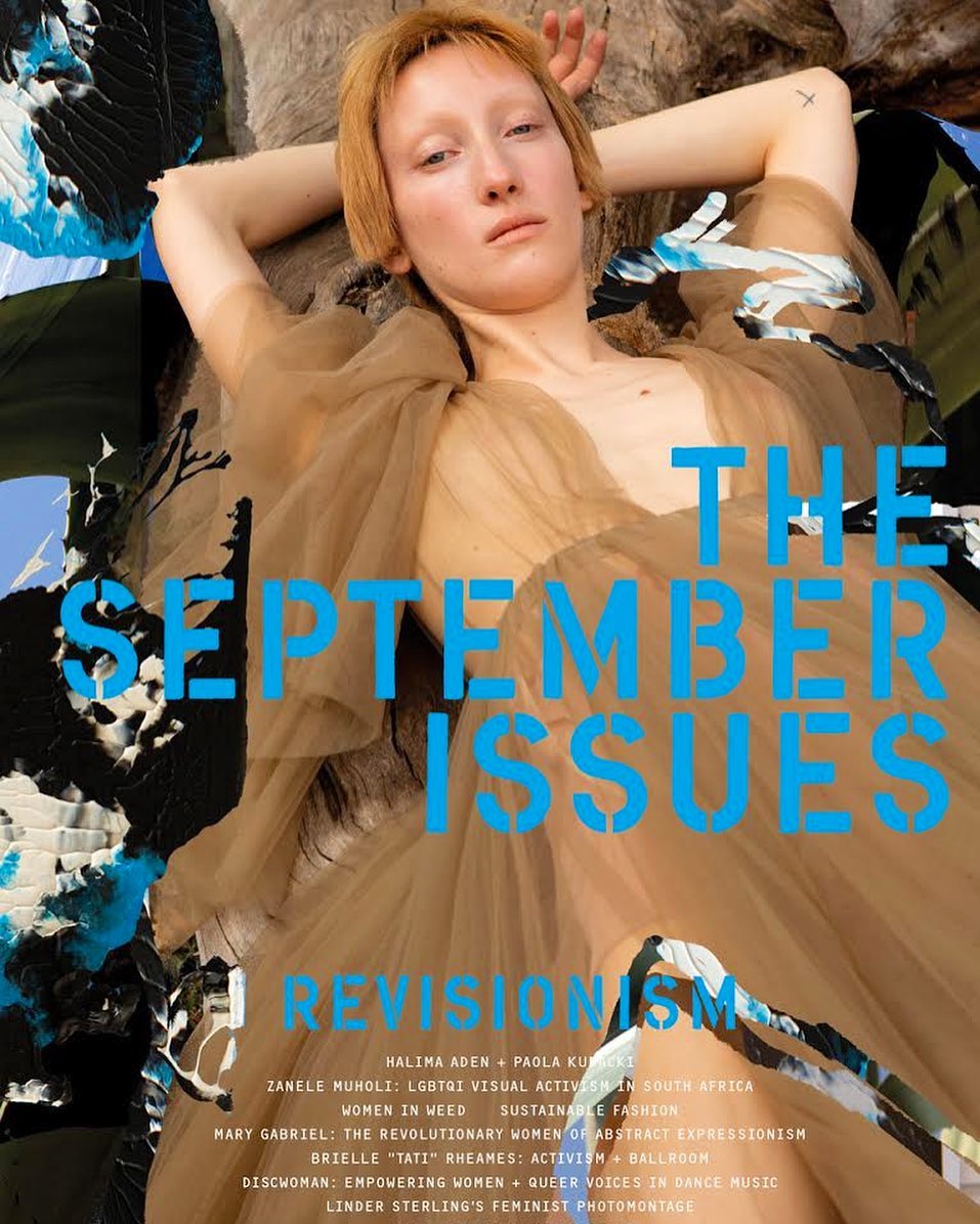 Magazine cover featuring a woman with short hair in a sheer dress lying near a tree, with overlaid text and graphics in blue.