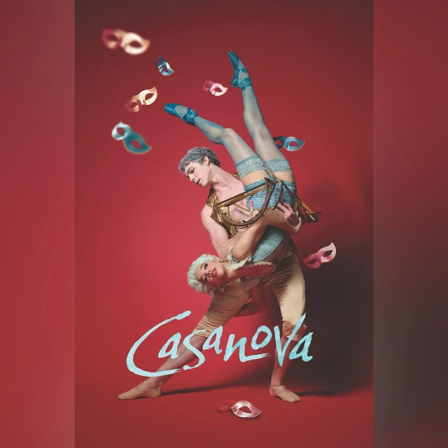Two dancers, one male carrying another male upside down, surrounded by floating Venetian masks against a red backdrop.