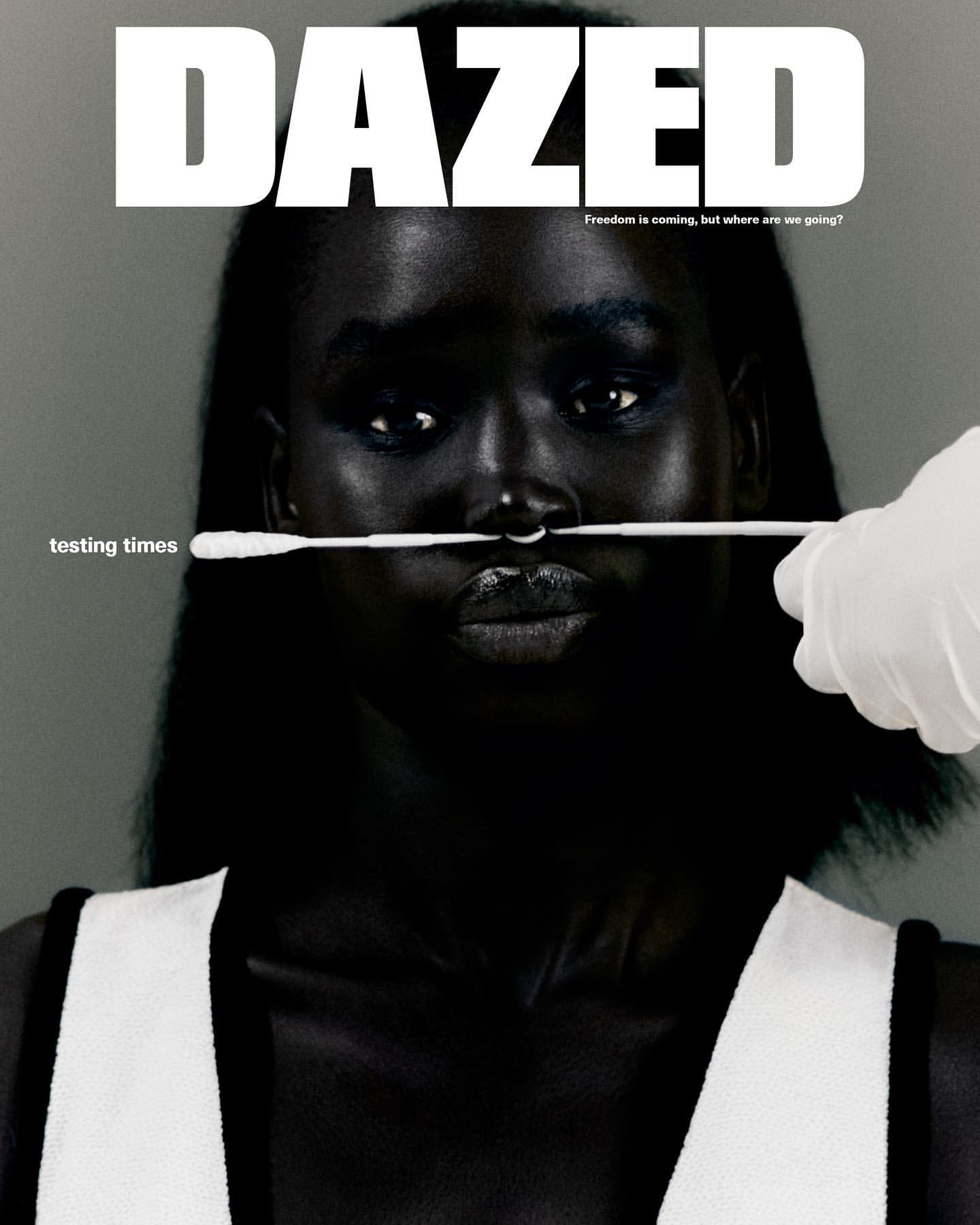 Magazine cover of a woman with dark skin getting a nasal swab test. The magazine title 'DAZED' is in bold white letters.