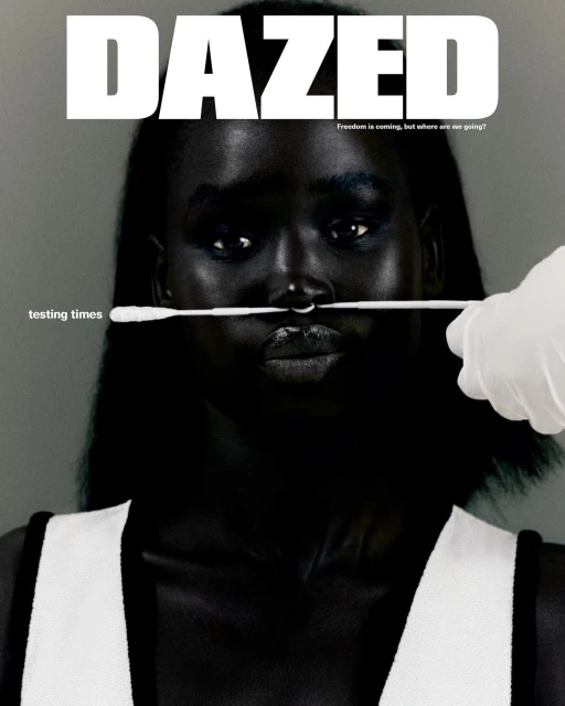 Magazine cover of a woman with dark skin getting a nasal swab test. The magazine title 'DAZED' is in bold white letters.