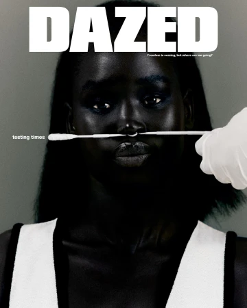 Magazine cover of a woman with dark skin getting a nasal swab test. The magazine title 'DAZED' is in bold white letters.