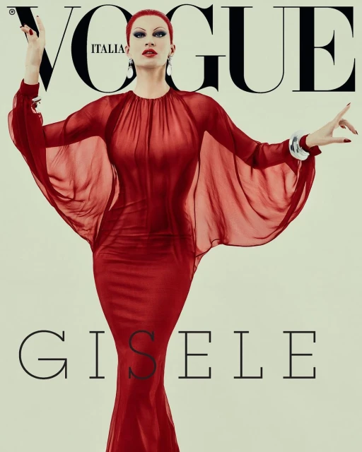 Vogue Italia cover featuring an adult woman with red hair wearing a long red dress and jewelry against a neutral background.
