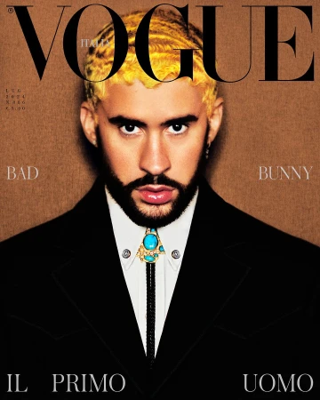 Vogue Italia magazine cover featuring a portrait of Bad Bunny in a black suit with gold hair against a brown backdrop, with prominent magazine text.