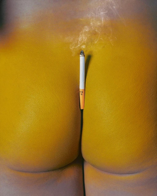 Surreal painting of a cigarette on a yellow surface, creating a minimalist yet suggestive image with abstract and sensual undertones.