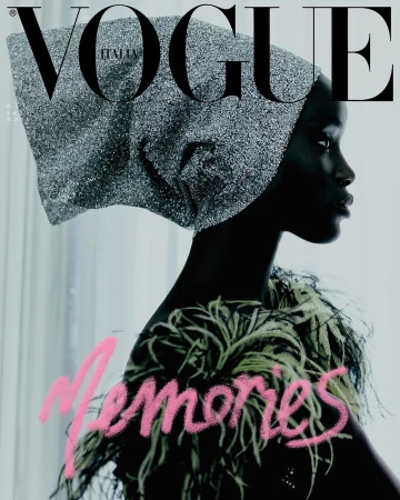 Vogue Italia cover features a Black female model in profile wearing a shimmering head covering and feathered top against a pale background.