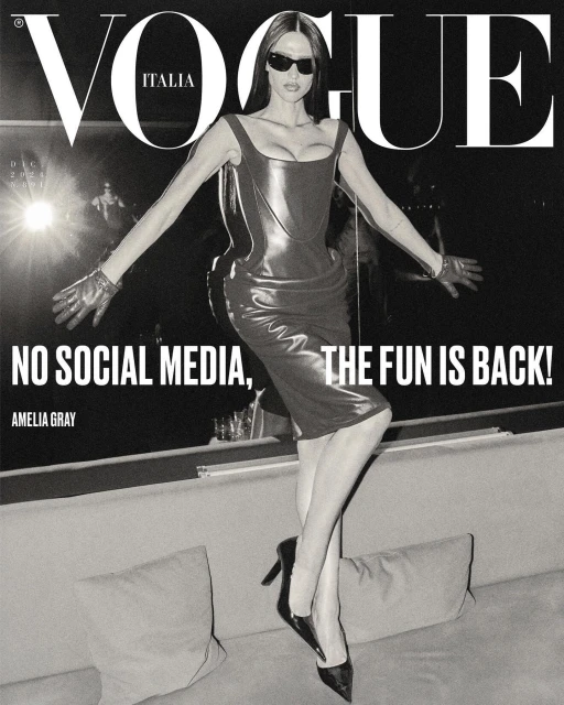 Vogue Italia magazine cover featuring Amelia Gray in a black dress and gloves, striking a pose on a textured couch.