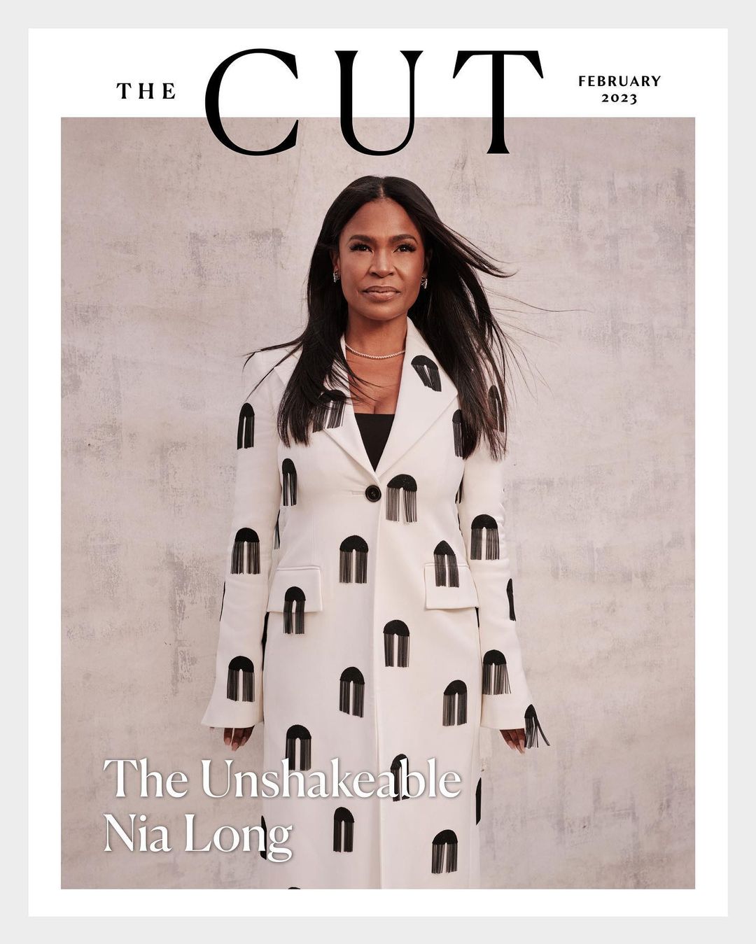 Magazine cover featuring Nia Long wearing a white coat with black U-shaped designs, against a textured gray background with publication text.