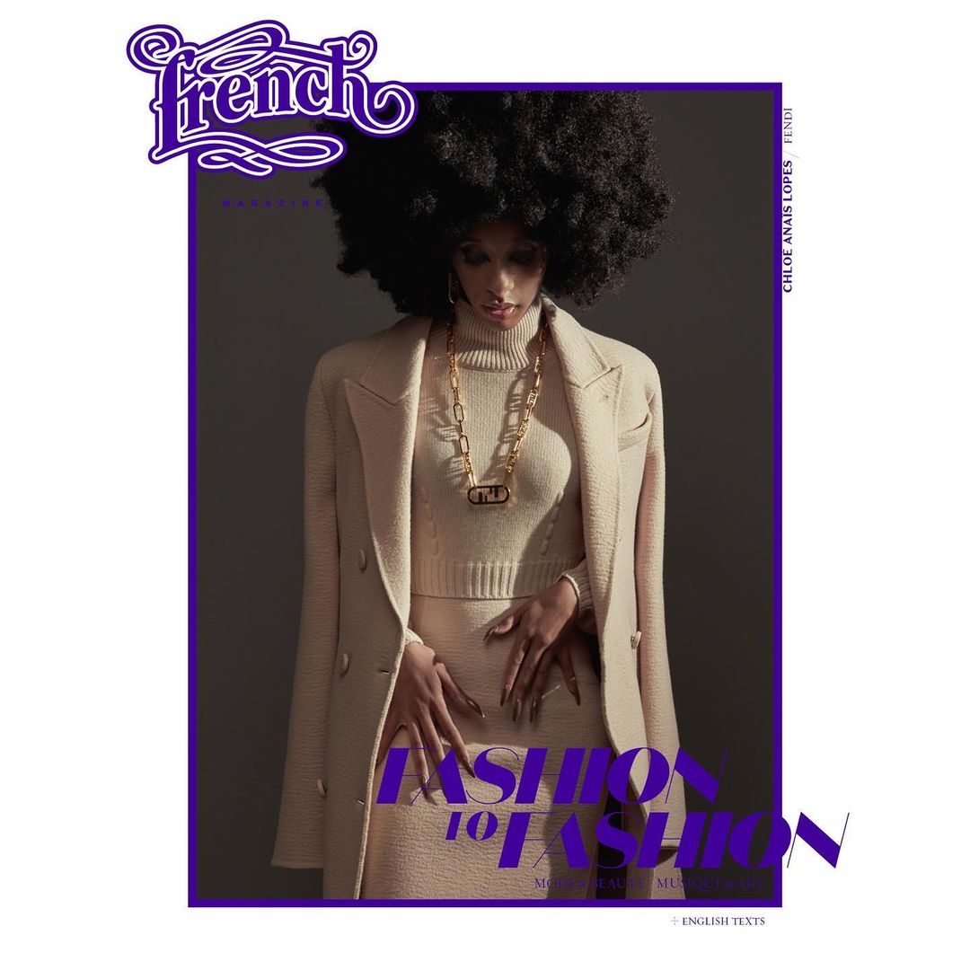 Magazine cover featuring a woman with an afro, wearing a beige outfit and gold jewelry, against a dark gray background with purple accents.