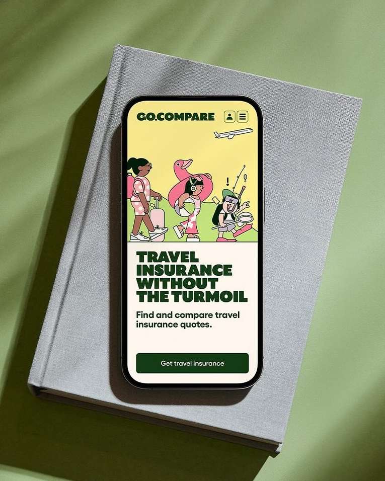 Travel insurance ad displayed on smartphone screen showing cartoon travelers, set on gray book against green background.