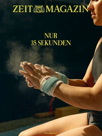 Magazine cover with a gymnast preparing for a routine, chalking hands with wrist supports, and dark background.