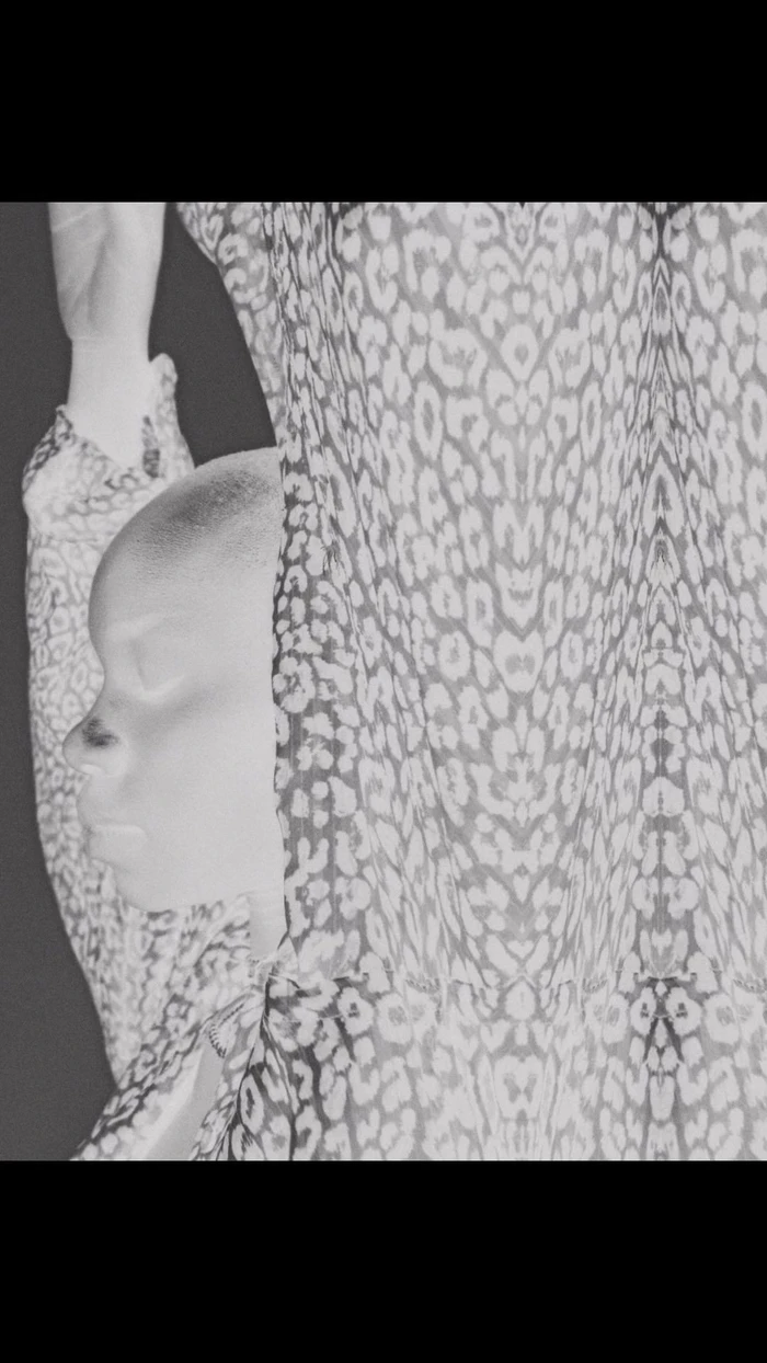 Monochrome portrait of a person with short hair wearing a patterned garment by photographer Ramon Haindl in Berlin.