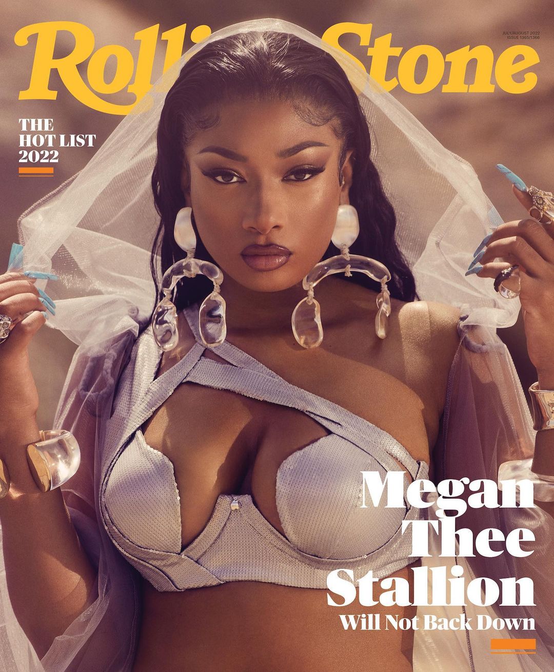 Rolling Stone cover featuring Megan Thee Stallion in a metallic bra and sheer veil, accessorized with large earrings and rings.