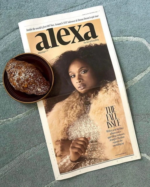 Alexa magazine cover with Jennifer Hudson, styled in sparkly dress with fur coat, poses next to croissant on light blue patterned textile.
