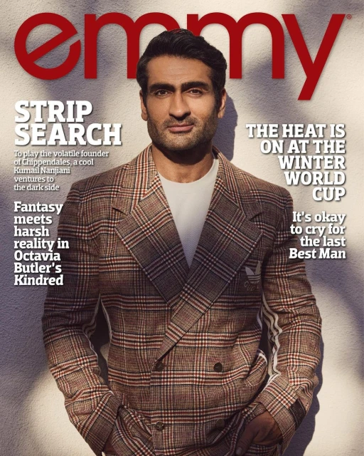 Magazine cover featuring a portrait of Kumail Nanjiani wearing a plaid blazer in front of an off-white textured background.