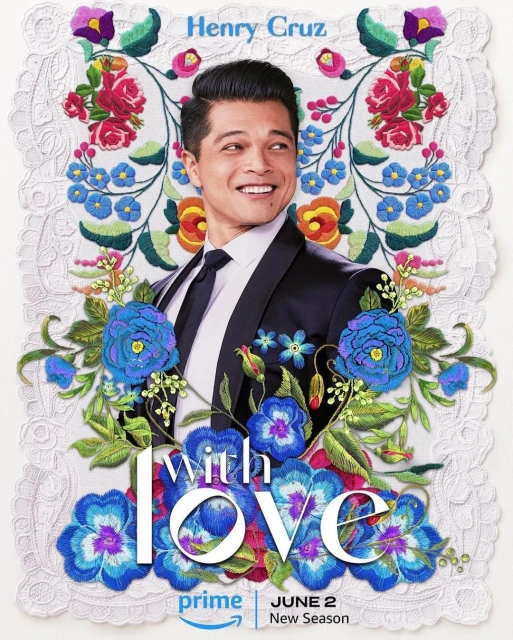 Promotional shot for the TV series 'With Love,' featuring a man in a suit smiling against a backdrop of embroidered flowers.