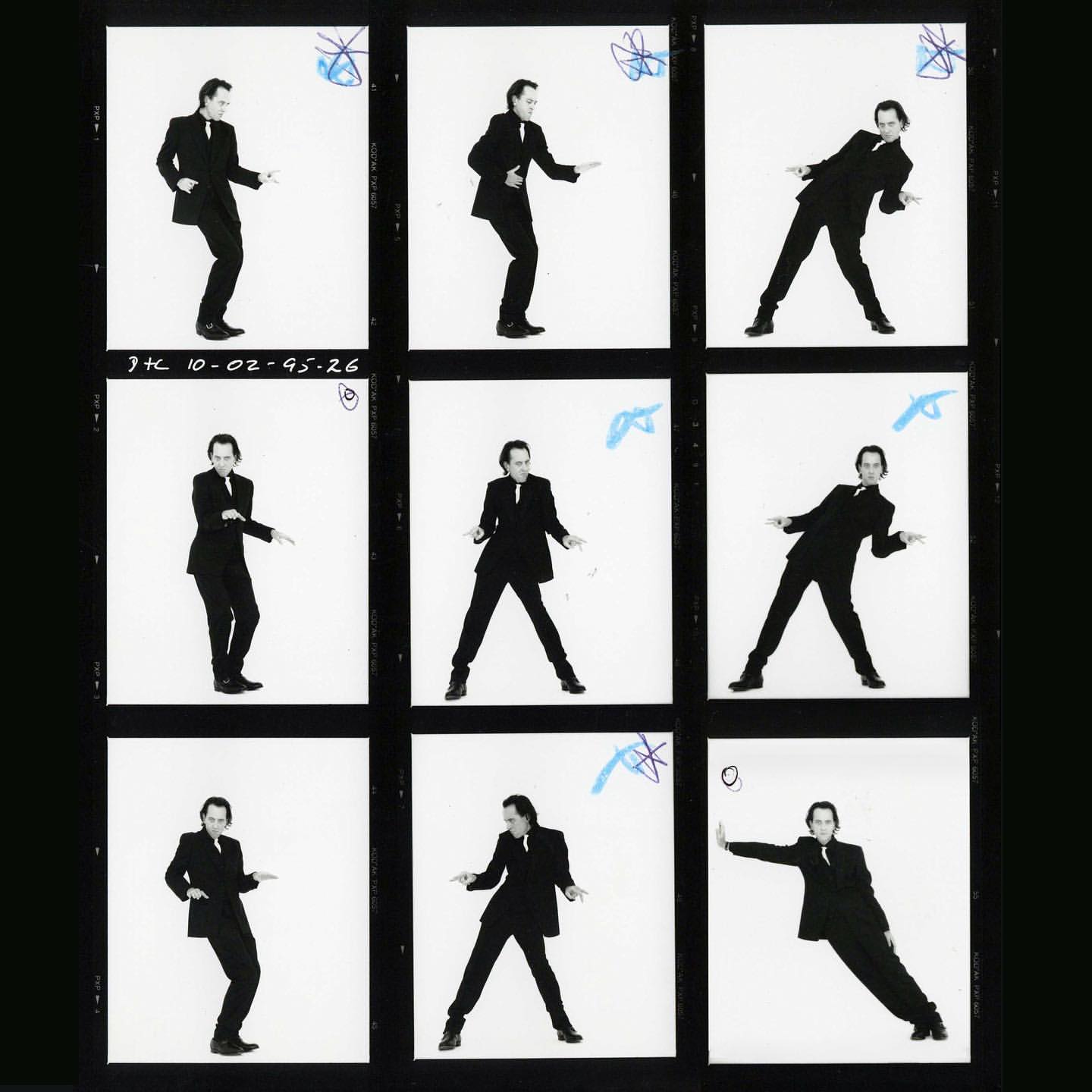 Black and white contact sheet features a man in a suit striking various poses against a plain white background, captured across nine frames.