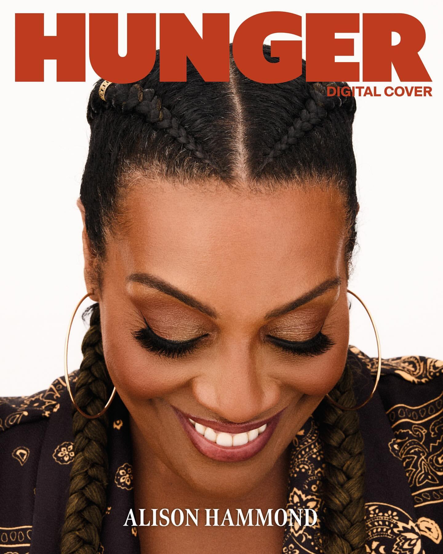 Close-up of Alison Hammond for 'Hunger' digital cover, smiling with eyes closed, wearing braids, hoop earrings and a patterned top.