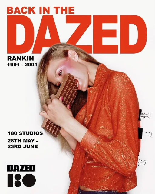 Woman in orange jacket biting a chocolate bar with text overlay featuring the words 'Back in the Dazed,' 'Rankin,' and '180 Studios'.
