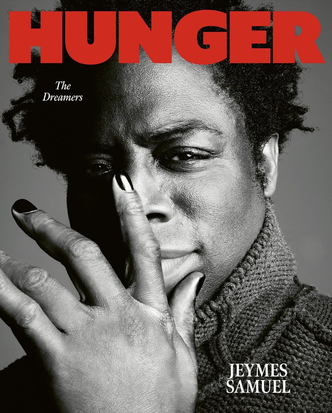 Black and white close-up of Jeymes Samuel on the cover of Hunger Magazine, hand to face, dark hair, wearing a textured sweater.
