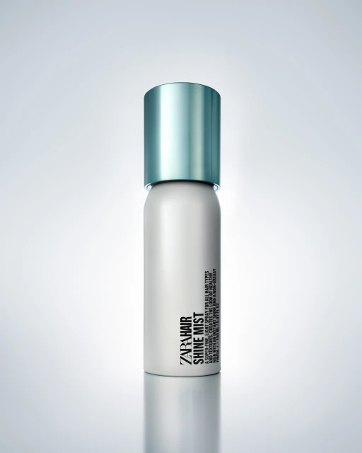 A single can of Zara Hair Shine Mist sits on a white surface with soft studio lighting and a subtle gradient background.