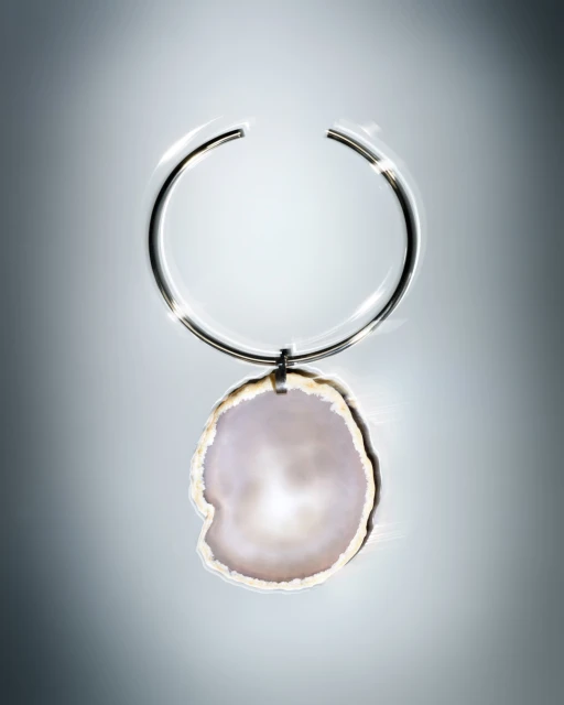 Pendant necklace with an open silver metal choker and a large organic white and cream colored pendant on a graduated gray background.