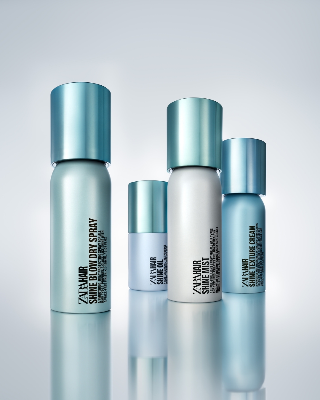 Four Zara Hair styling products including Shine Blow Dry Spray, Shine Oil, Shine Mist and Shine Texture Cream with light blue accents.
