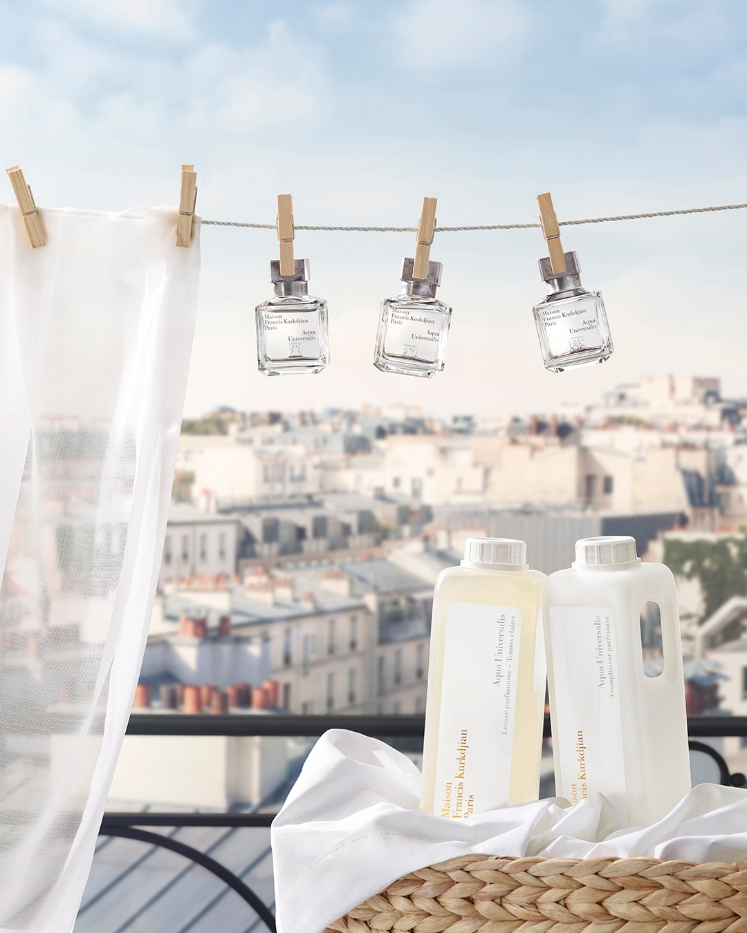 Laundry detergent and perfume bottles arranged with clothespins, a woven basket, and a cityscape background create a clean and fresh aesthetic.