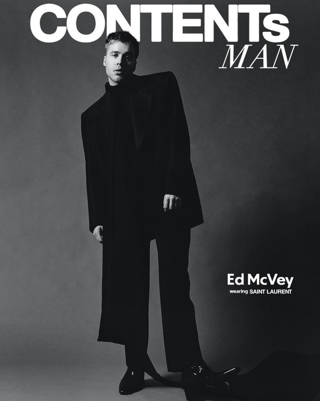 Black and white magazine cover featuring a young man in a black suit. The cover includes the magazine's title and the model's name.