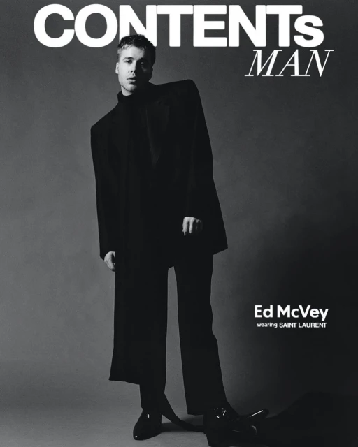 Black and white magazine cover featuring a young man in a black suit. The cover includes the magazine's title and the model's name.