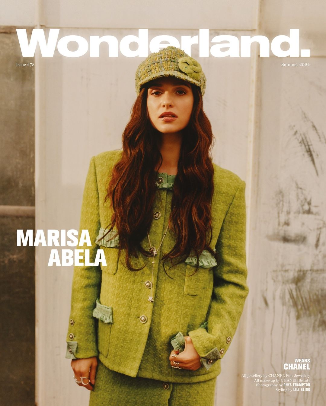 Marisa Abela poses on the cover of Wonderland magazine wearing a lime green tweed suit and matching hat with flower detail. 
