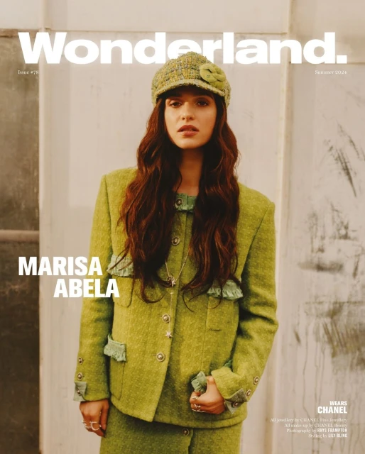 Marisa Abela poses on the cover of Wonderland magazine wearing a lime green tweed suit and matching hat with flower detail. 