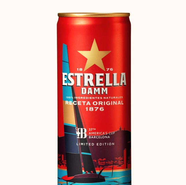 Estrella Damm beer can featuring a sailing regatta design, celebrating America's Cup Barcelona, displayed against a plain background.