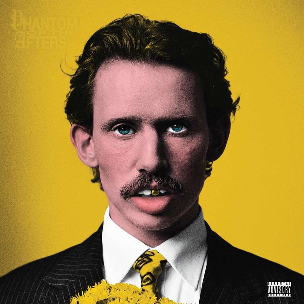 Portrait of an adult male with a mustache wearing a suit and tie, with a yellow background and dandelions in front of him.