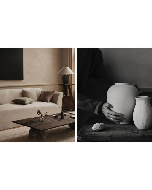 Monochromatic indoor interior scene featuring two ceramic vases being held by a person, with a neutral-toned living room in the background.
