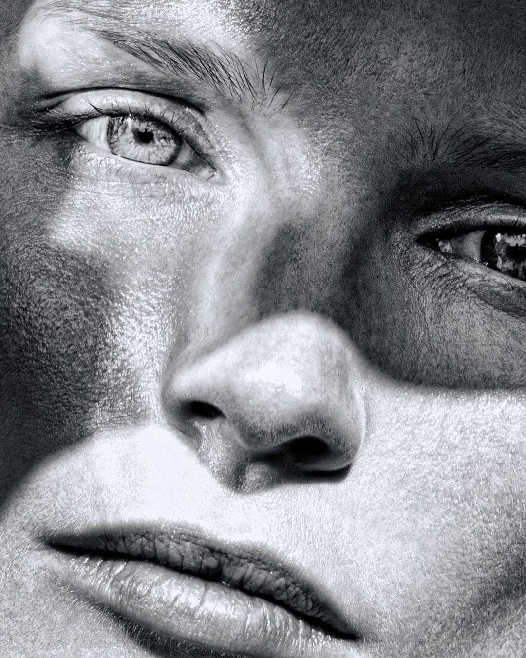 Extreme close-up portrait of a woman face with high contrast monochrome grain texture captured by photographer Rayan Ayash.