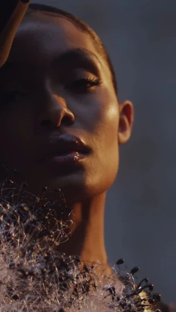 Close-up portrait of a woman with glossy lips wearing a textured white garment by photographer Rayan Ayash.