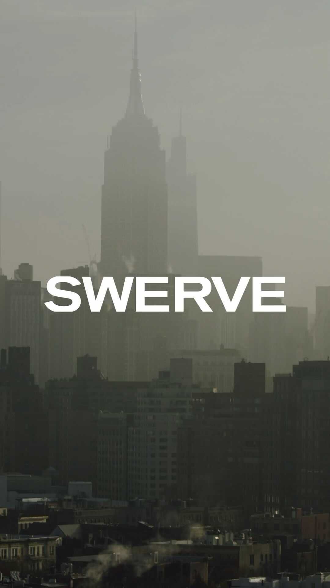New York City skyline featuring the Empire State Building in a misty or foggy atmosphere, highlighting the architecture of the cityscape.