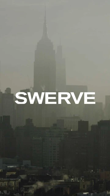 New York City skyline featuring the Empire State Building in a misty or foggy atmosphere, highlighting the architecture of the cityscape.