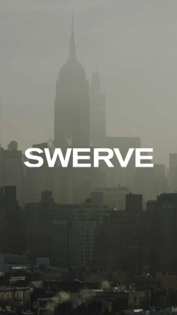 New York City skyline featuring the Empire State Building in a misty or foggy atmosphere, highlighting the architecture of the cityscape.