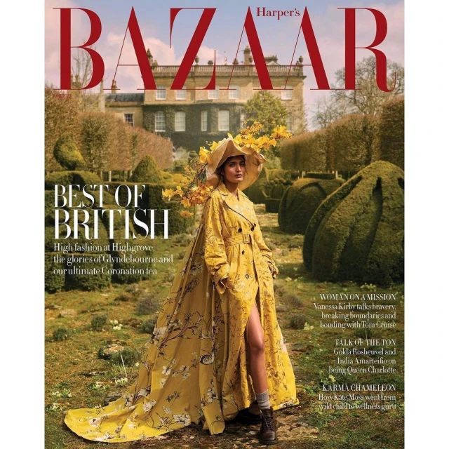 Harper's Bazaar magazine cover featuring a woman in a yellow floral trench coat and hat standing in a garden with a mansion backdrop.