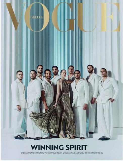 Vogue Greece magazine cover featuring a group of adult males and one adult female wearing formal white attire and a gold dress.