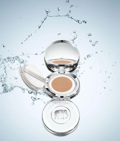 Chantecaille compacts floating in a blue and white space surrounded by water droplets in a beauty and product shot, luxury.