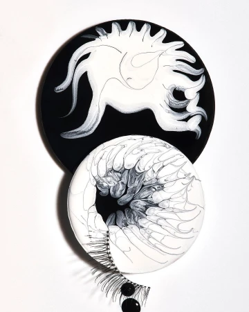 Abstract art featuring black and white circular forms with eyelash accents against a white backdrop. Minimalist aesthetic and design focus.