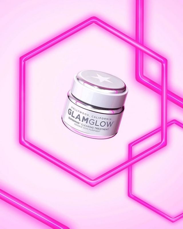 GlamGlow skincare product jar with geometric neon pink lights on a pink gradient background in a beauty shot for advertising.