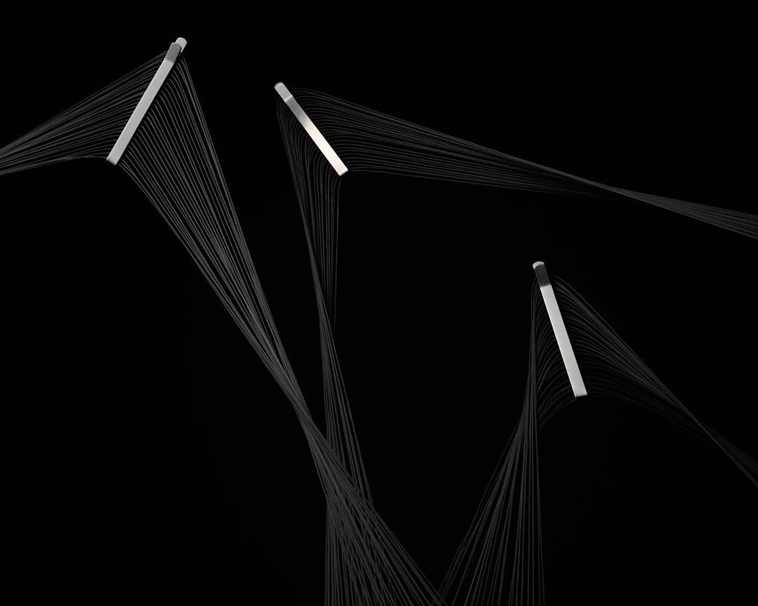 Abstract photo of silver bars with cascading grey threads against black, creating a minimalist yet dynamic visual composition.