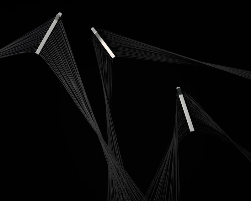 Abstract photo of silver bars with cascading grey threads against black, creating a minimalist yet dynamic visual composition.