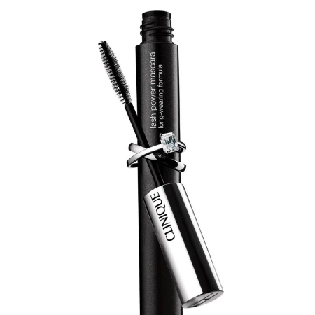 Clinique lash power mascara in black with brush applicator, adorned with a diamond ring on a white backdrop, beauty product.