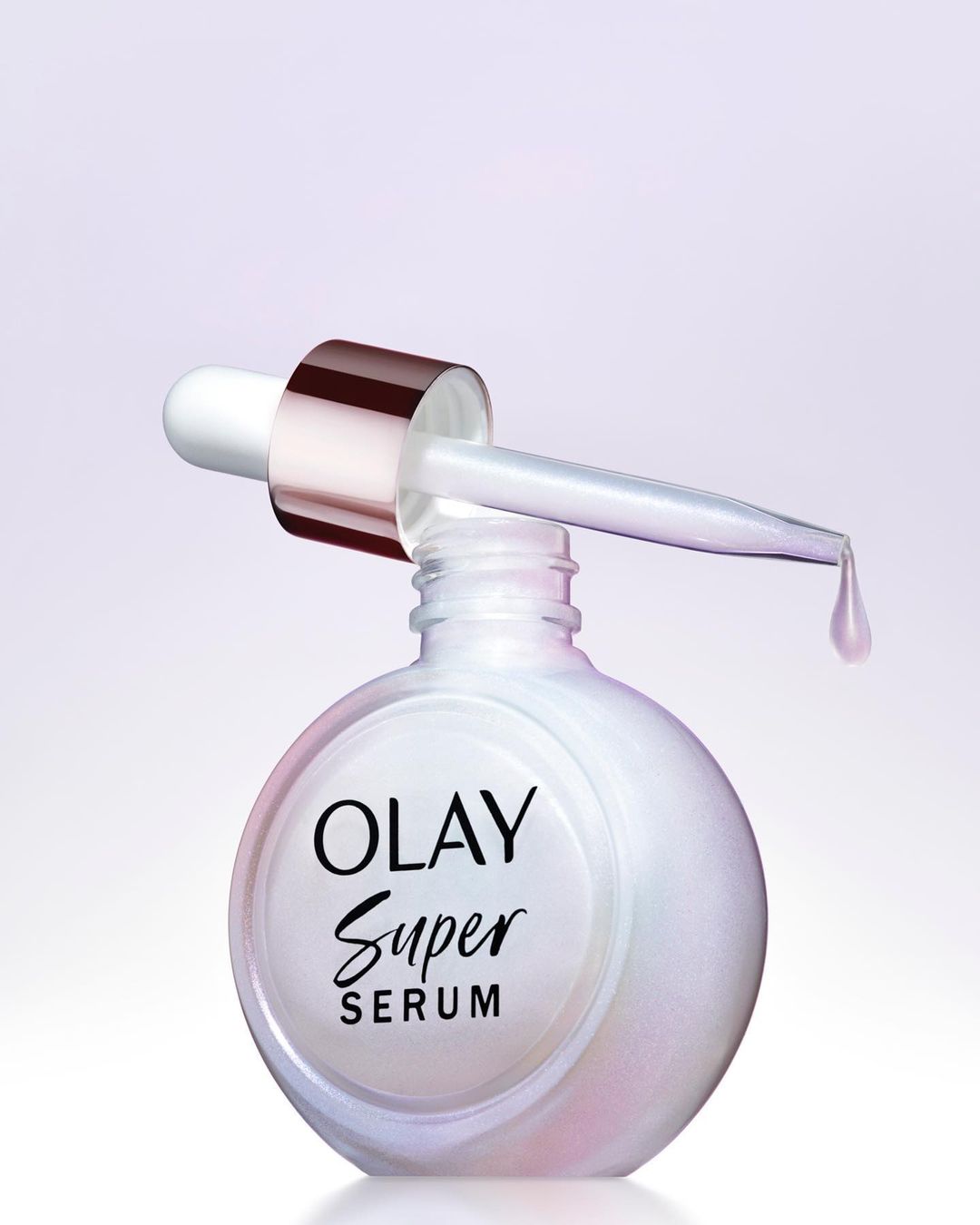 Close-up studio shot of Olay Super Serum bottle with dropper. Product focus with cosmetic and beauty industry theme, featuring white bottle.