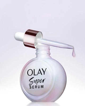 Close-up studio shot of Olay Super Serum bottle with dropper. Product focus with cosmetic and beauty industry theme, featuring white bottle.